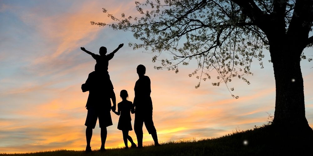 A healthy and happy family outside as the sun is rising.